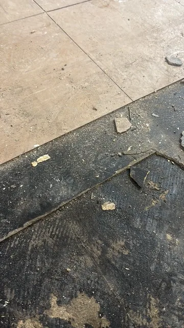 Black bitumen mastic floor removal in a SE15 flat